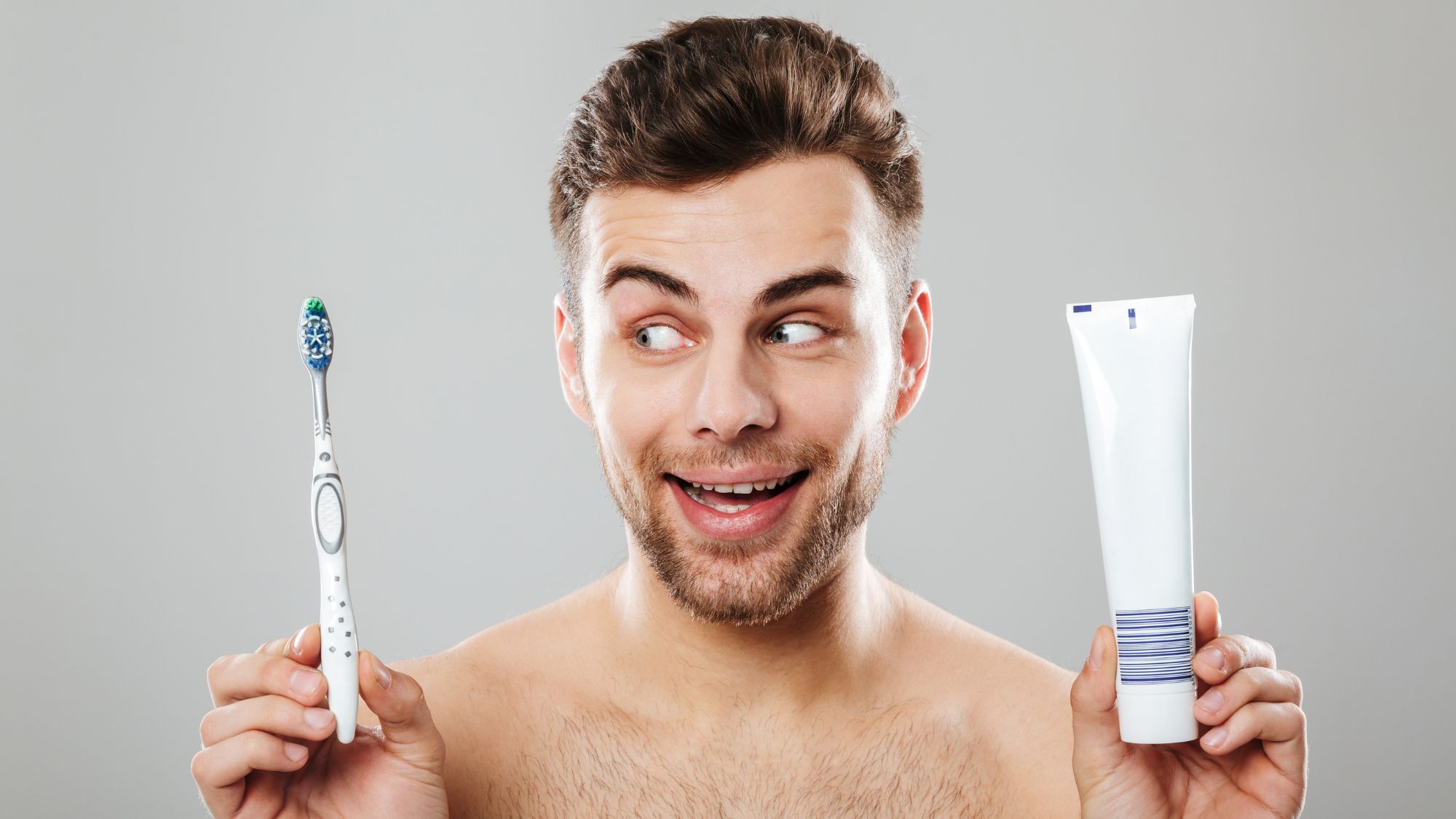A half-naked man emphasizing the importance of brushing and the top 10 toothpastes for sensitive teeth, trusted by dentists